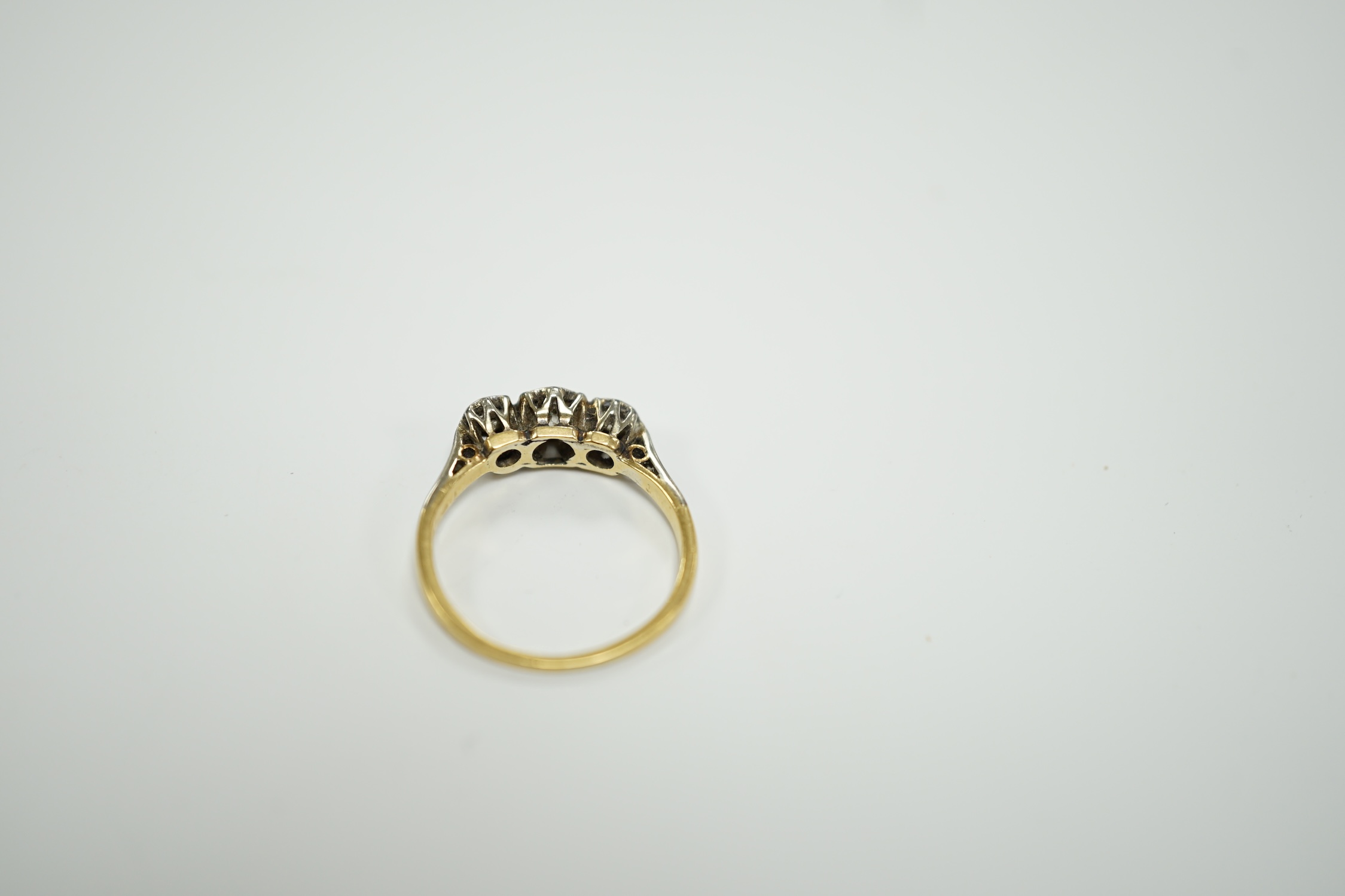 An 18ct and illusion set three stone diamond ring, size I, gross weight 2 grams.